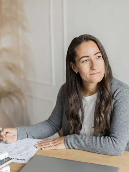 Jennifer Keable, life coach and work life balance coach, sitting at a desk after a coaching session with a client.