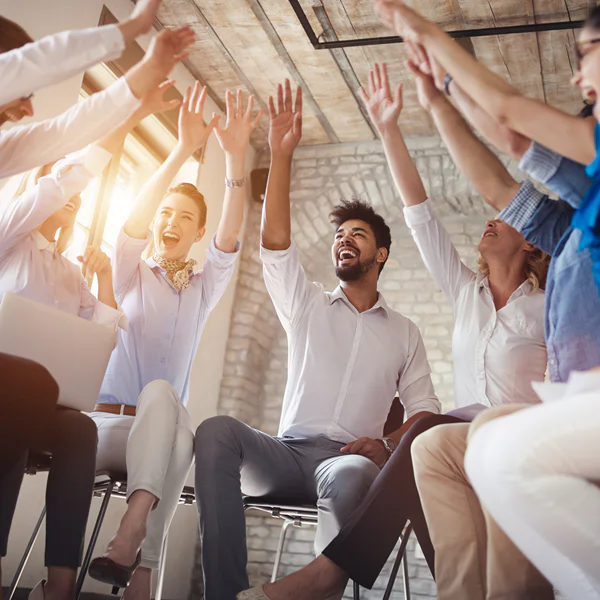 Image of a group of people with raised hands excited to be developing healthy habits.